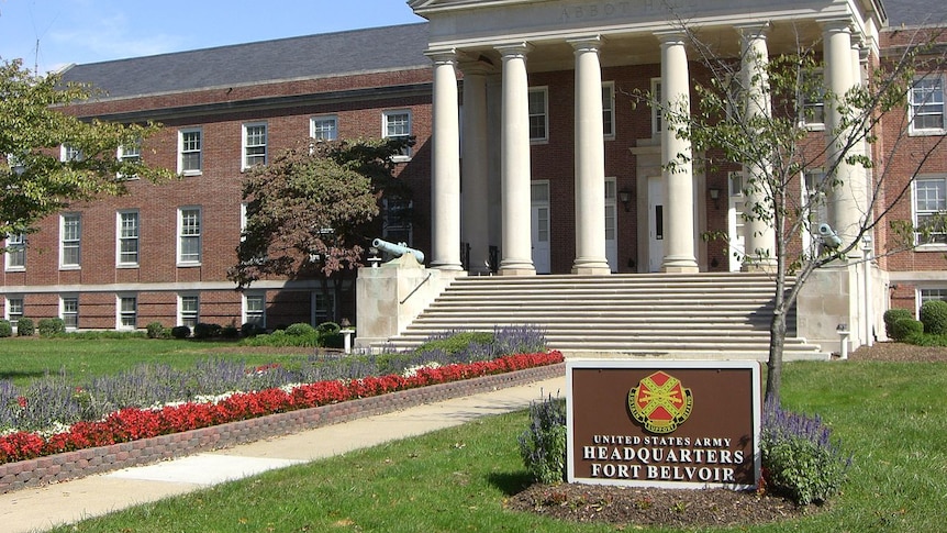 The front of the army headquarters at Fort Belvoir, Virginia. There is a garden, steps and a facade with white columns.