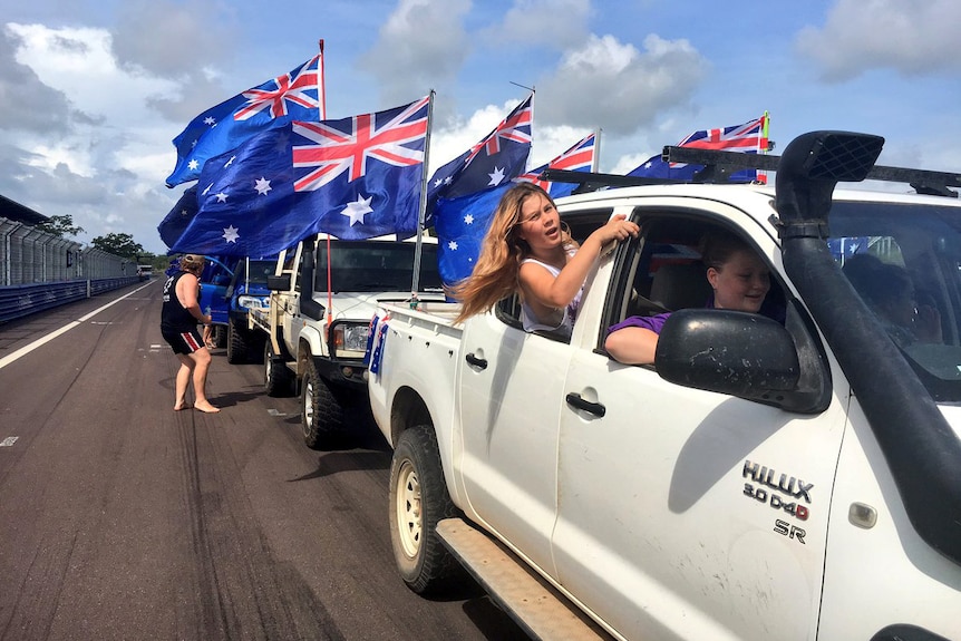 A group of utes participate in the annual Variety ute run in Darwin
