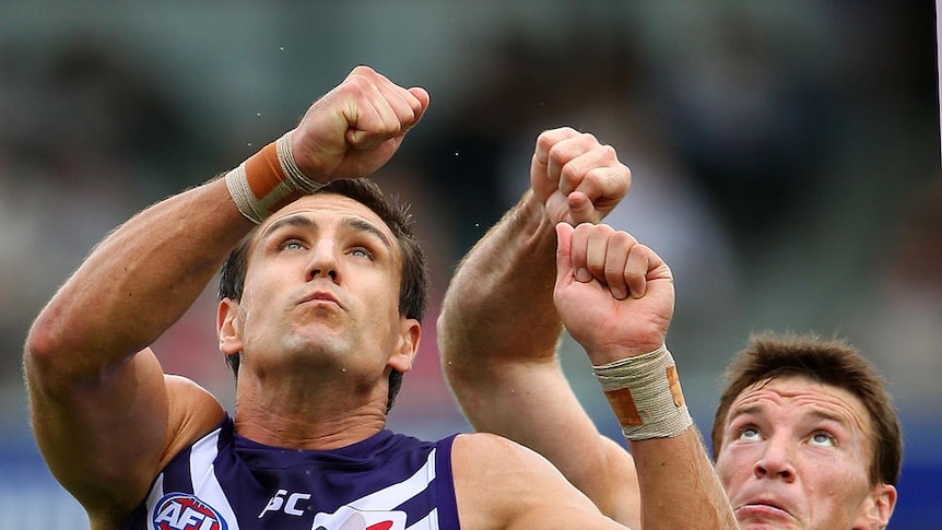 Clash of the stars... Matthew Pavlich and Brent Harvey contest a boundary throw-in at Patersons Stadium.