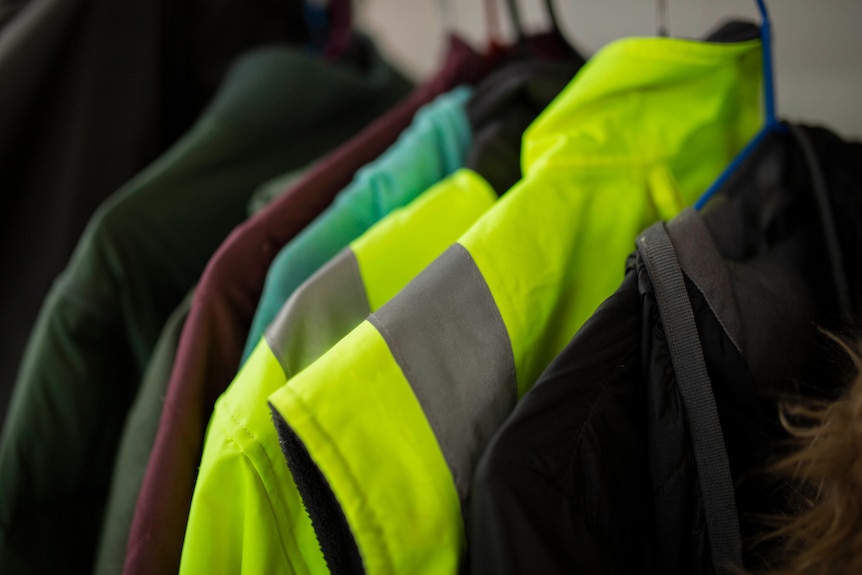 high vis workwear hanging in cupboard