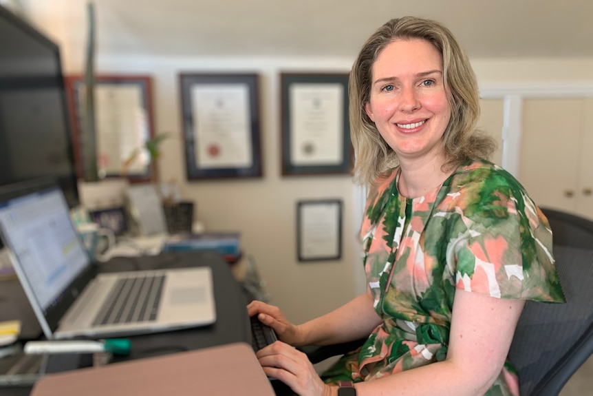 Economist and Grattan Institute chief executive Danielle Wood sits at her laptop computer.