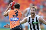 Stephen Coniglio of the Giants is challenged by Jonathon Marsh of the Magpies
