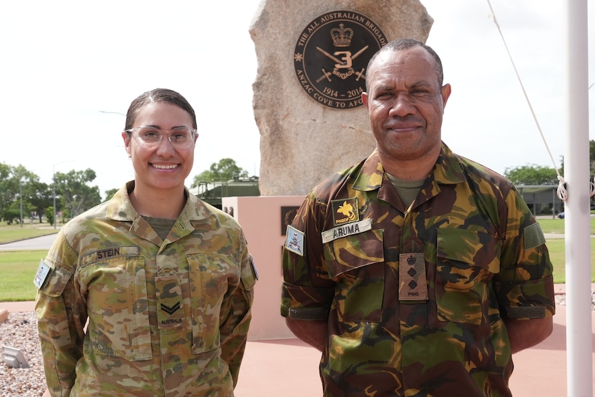 Corporal Talita Stein and colonel Boniface Aruma wear their uniform as they smile to the camera. 