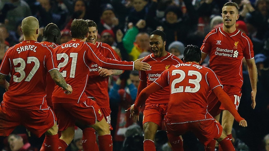 Liverpool's Raheem Sterling (3rd R) celebrates his League Cup semi-final goal against Chelsea.