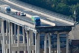 A truck on the edge of collapsed bridge.