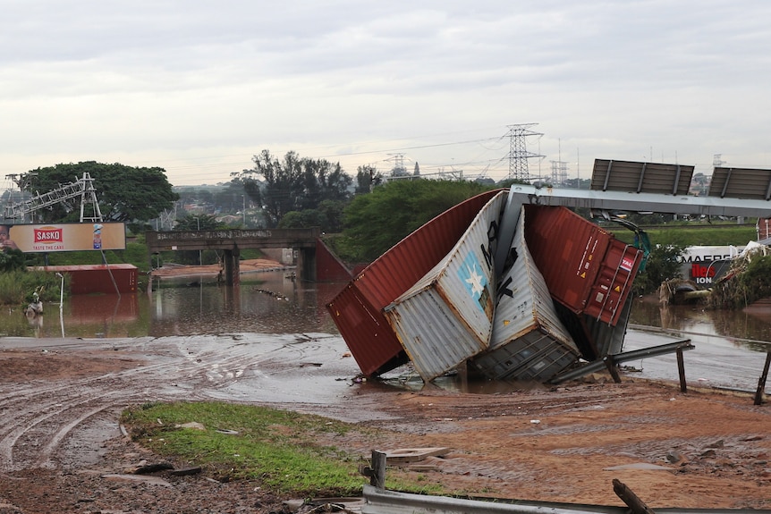 Shipping containers left in a jumbled pile after flooding