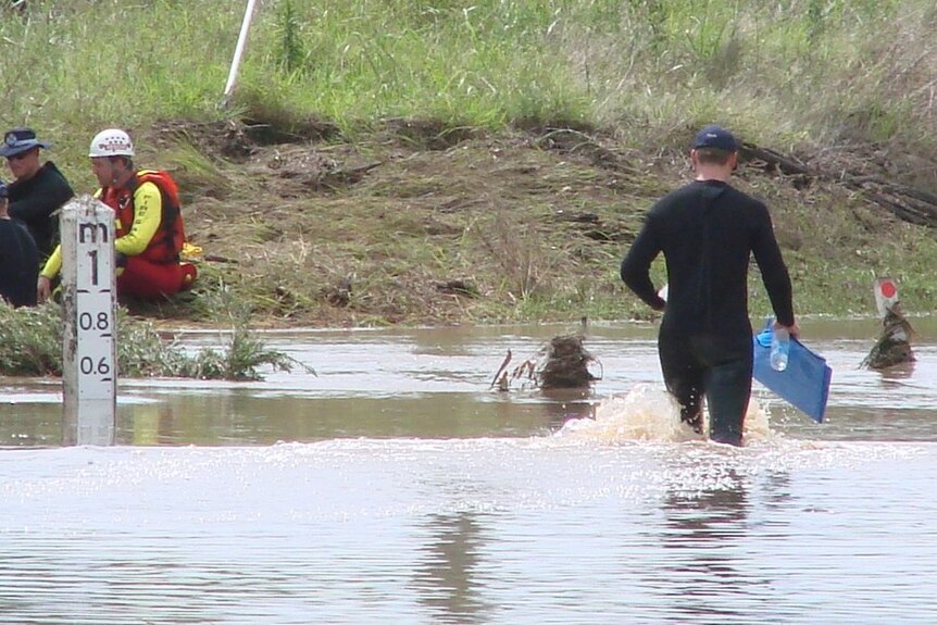 Police and Fire and Rescue Service divers at the scene of a fatal accident at Laidley Creek.