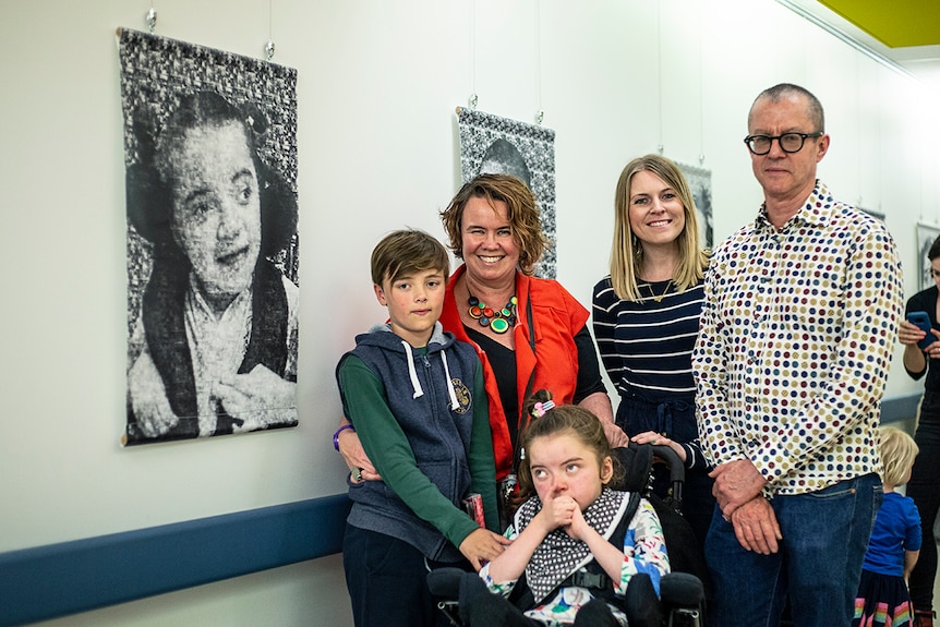 Photo of Redmond, Kate and Adania Evans with teacher Clare Devlin-Mahoney and Frank Beard at A Little Piece of Me exhibition.