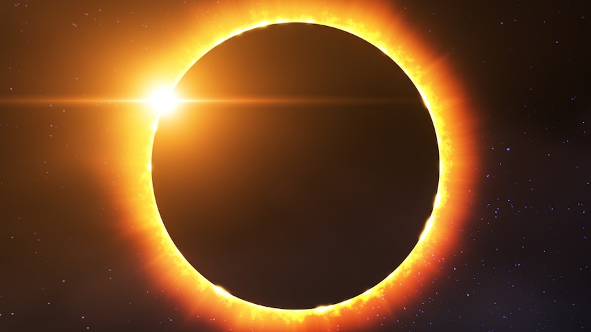 A solar eclipse showing the dark moon framed by the golden sun