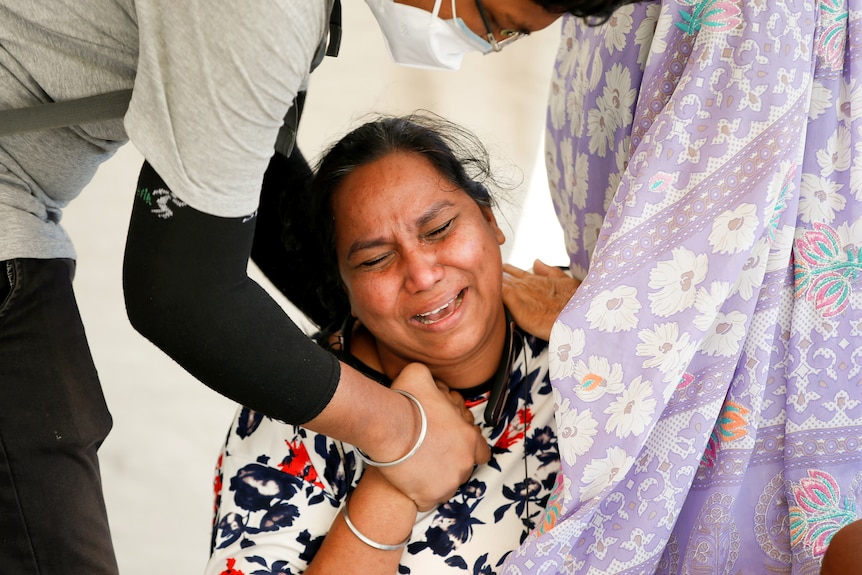 Woman is consoled in India