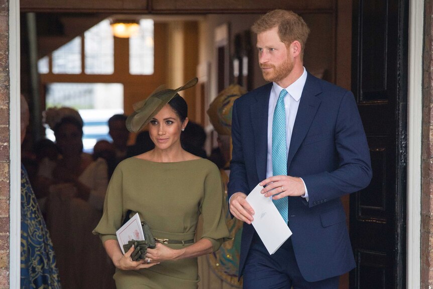 Britain's Prince Harry and Meghan Duchess of Sussex leave after the christening service