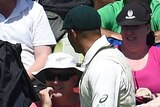 Usman Khawaja looks at a sign in the crowd pointed towards him
