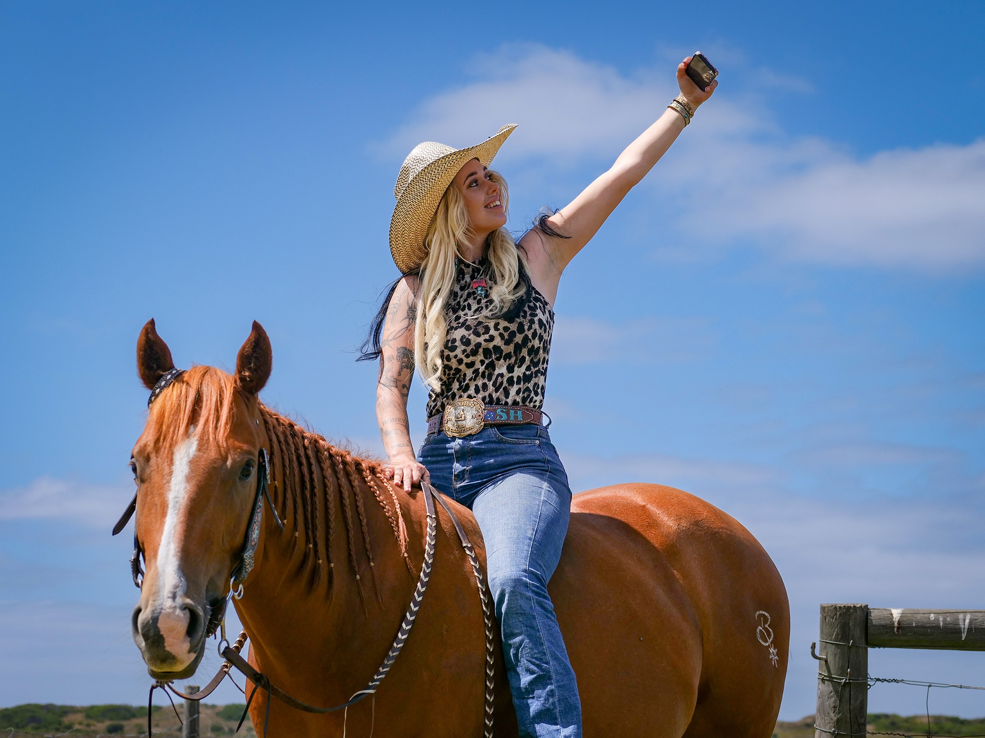 A woman takes a selfie on a horse
