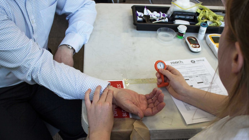 Generic shot of a nurse taking an unidentified man's pulse.