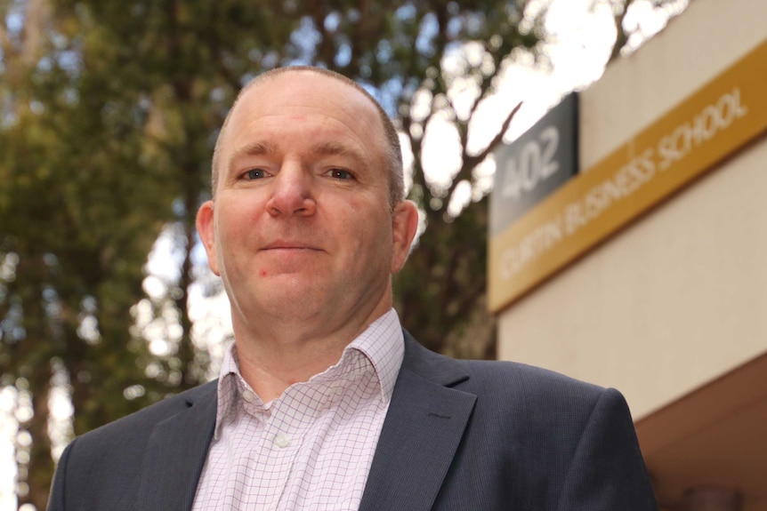 An image of Steven Rowley with a Curtin University Business School in the background.