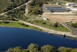 An aerial shot of a large lake of water near a waste water treatment facility.