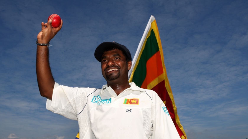 Muttiah Muralidaran holds the ball up in celebration of his world record 709th Test wicket