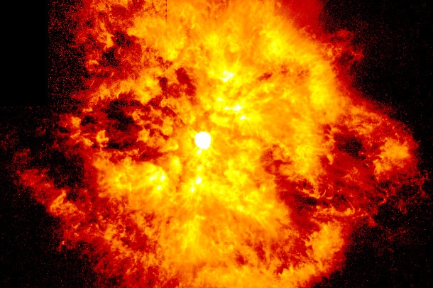 An image of star WR124 a few decades ago. In the middle a circle with what looks like fire surrounding it.
