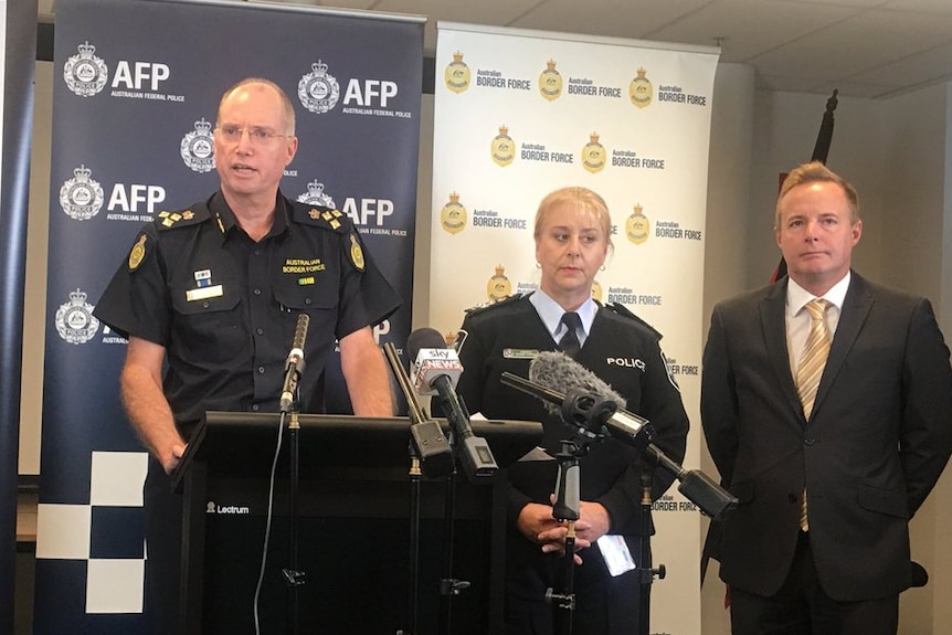 Four representatives from the Queensland Joint Organised Crime Task Force address media in Brisbane at an AFP press conference.
