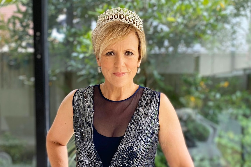 New Zealand TV personality Hilary Barry dresses up for #FormalFriday on social media behind a laptop computer.