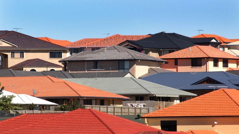 A view of a housing estate, with a number of different coloured-roofs.