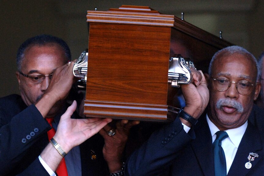 Tommie Smith and John Carlos carry the coffin of Peter Norman in 2006.