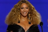 Beyonce smiles at podium