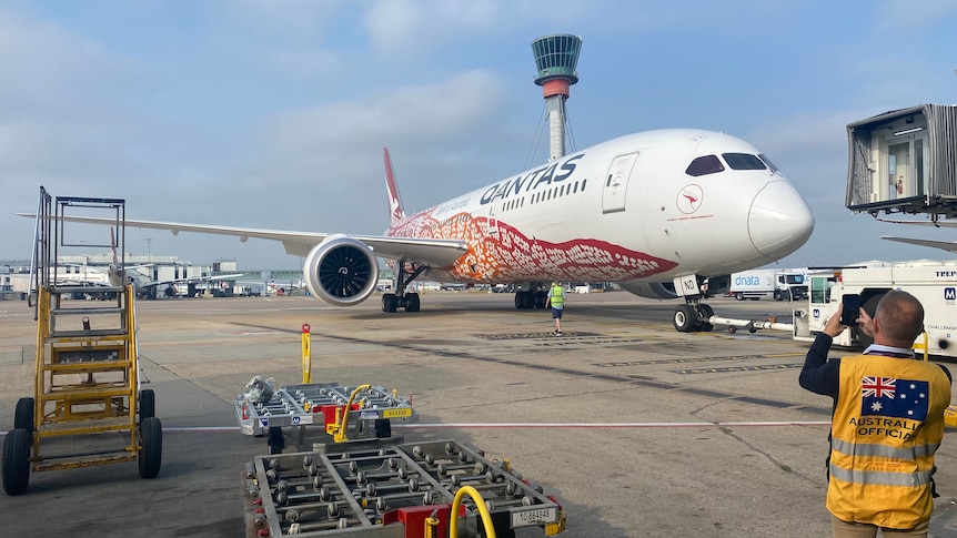 A Qantas plane loaded up with a Pfizer vaccine shipment waits to take off for Australia from the UK.