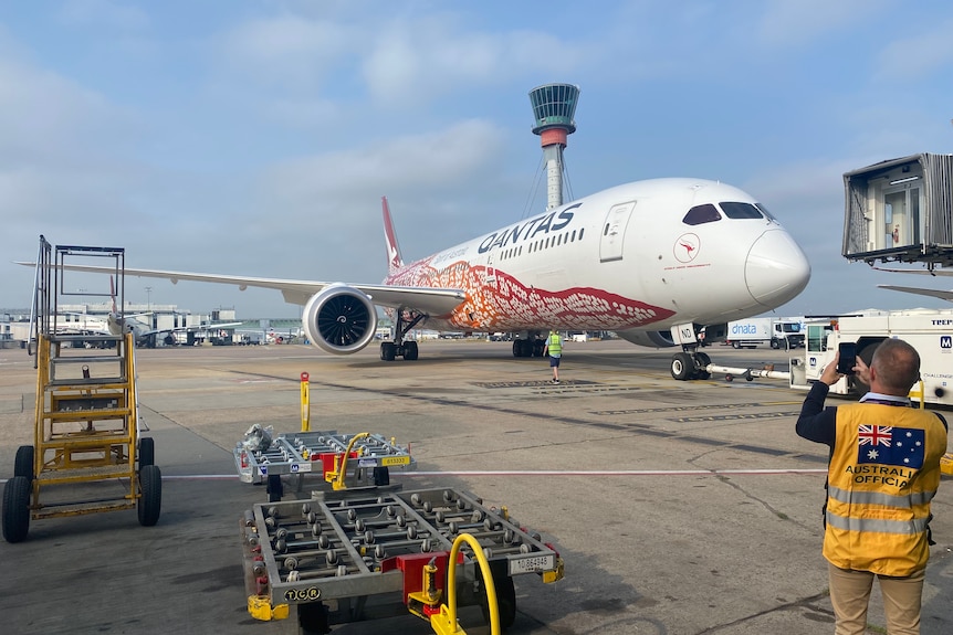 A Qantas plane loaded up with a Pfizer vaccine shipment waits to take off for Australia from the UK.