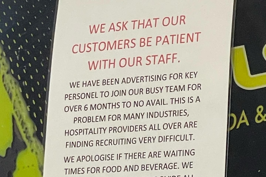Sign asking customers be patient with staff.