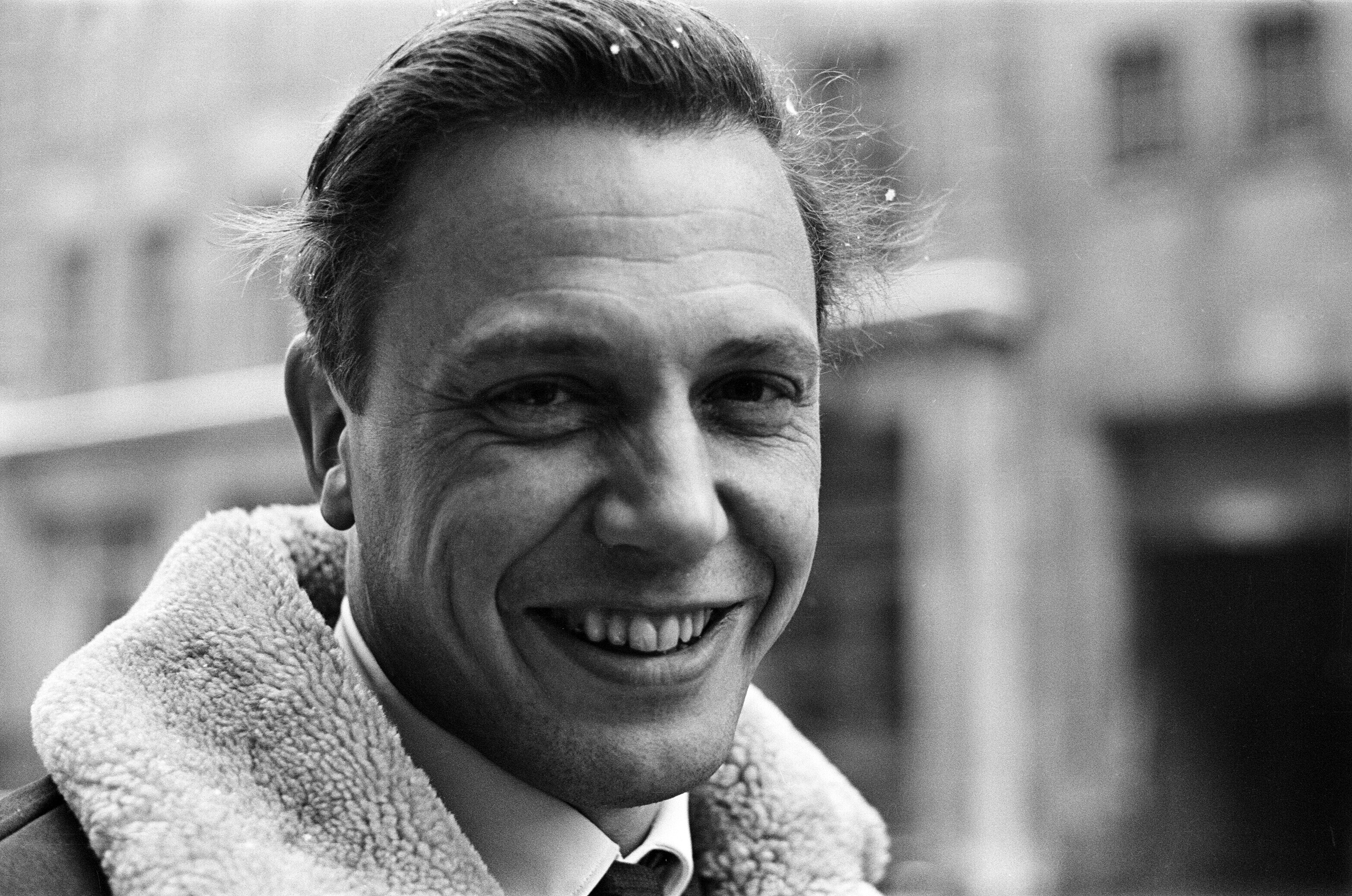 A close up shot of a young man in a suit.