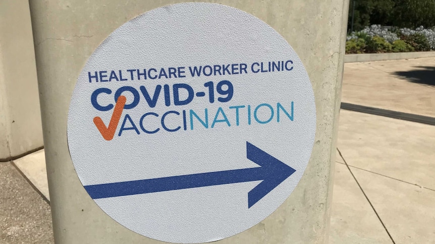 A sign at the Royal Adelaide Hospital points the way to a COVID-19 vaccination clinic.
