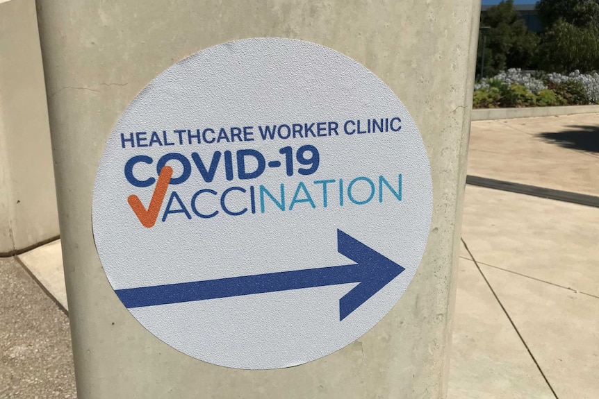 A sign at the Royal Adelaide Hospital points the way to a COVID-19 vaccination clinic.