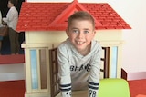 A child climbs through a toy house at the Perth Children's Hospital.