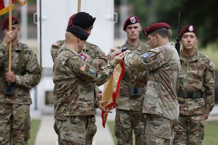 Soldiers take part in a ceremony of renaming a US army base.