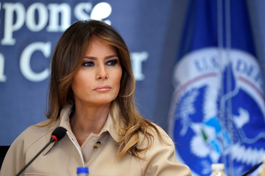 US first lady Melania Trump looks off to the right.