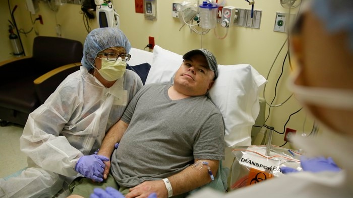 US man Brian Madeux, the first person to receive gene therapy in body, lies in a bed.