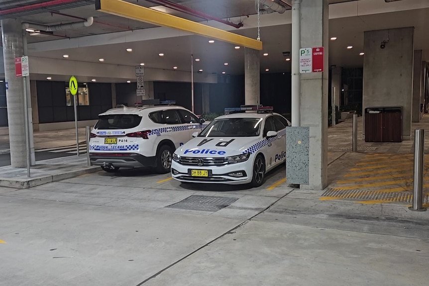 two new south wales police cars at the carpark at westmead hospital after an incident
