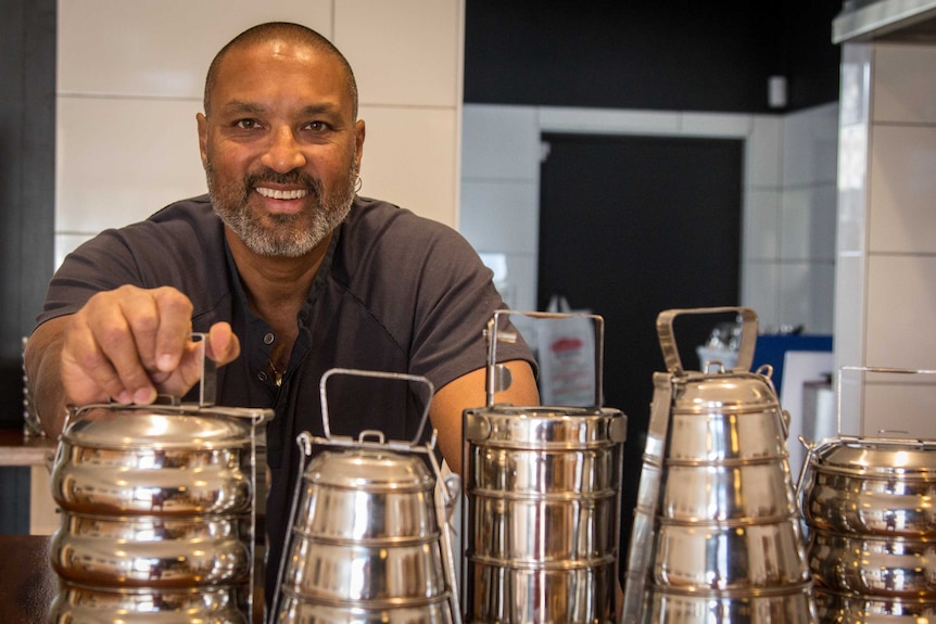 Restaurant owner Jay Clarke with tiffins for takeaways