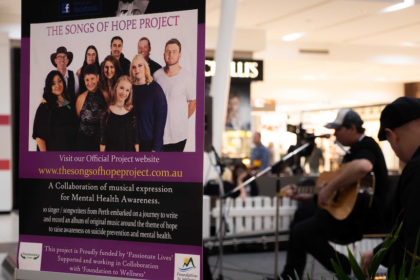 A banner showing the 'songs of hope project' with a person playing a guitar in the background