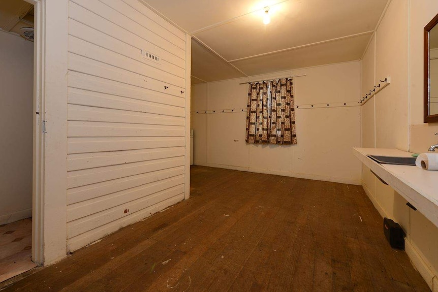 A kitchen with a sink in the right hand side. The room is in an old church