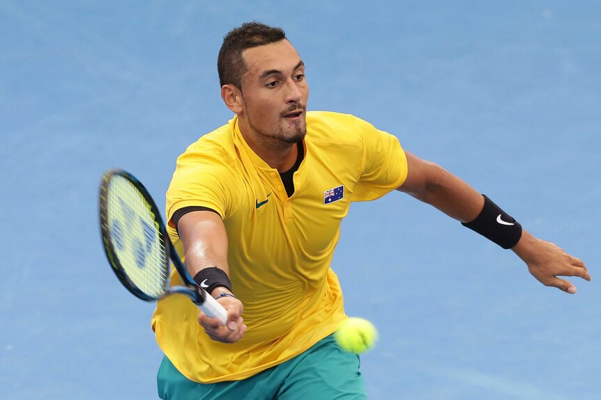Australia's Nick Kyrgios hits a return against Sam Querrey of the United States in Davis Cup.