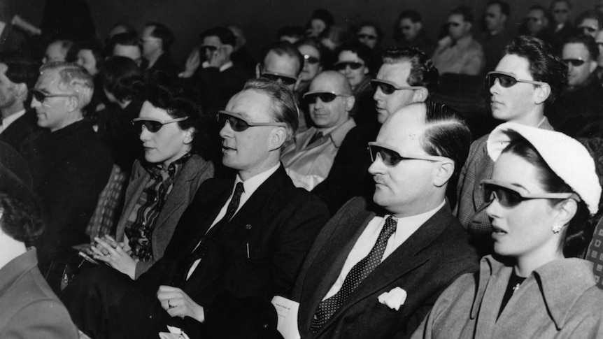 People watch a movie wearing 3D glasses