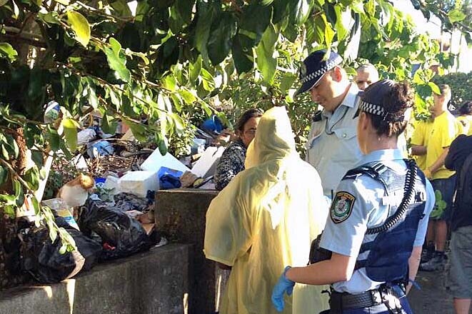 Police intervene in the clean up outside Bondi home