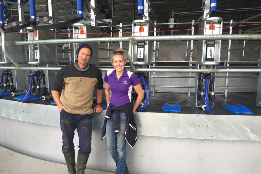 Chris Apps and daughter Ebony standing in front of their new rotary dairy