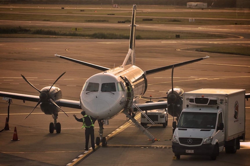 A pilot checks a REX Regional Express Aircraft before flight, Brisbane Domestic Terminal June 4, 2020.