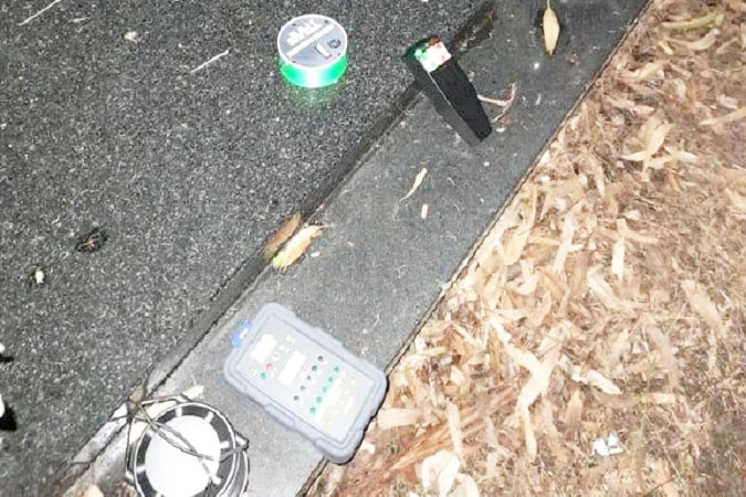 Several alleged ghost hunting devices on a grave.