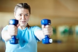 Woman with dummbells at the gym