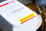 An Australia post parcel from a compounding pharmacy on a table.