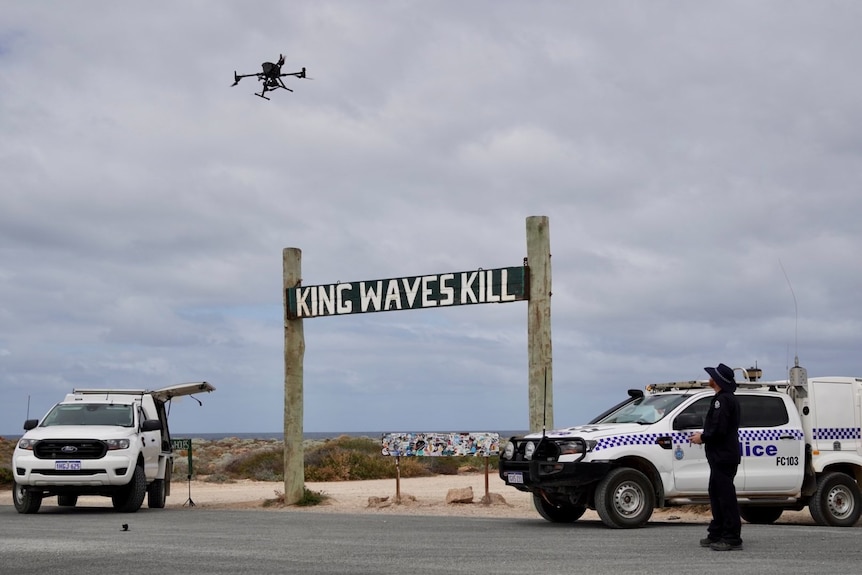 A drone flying above a 'King Waves Kill' sign